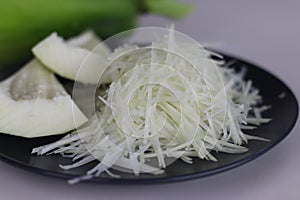 Fresh raw green papaya and shredded papaya on display, perfect for healthy recipes and vibrant salads