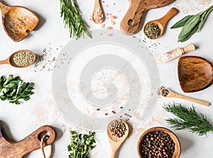 Fresh raw Herbs, various spices and wood kitchen were frame on textured background. top view