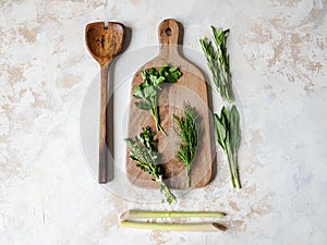 Fresh raw Herbs and wood kitchen were frame on textured background. top view