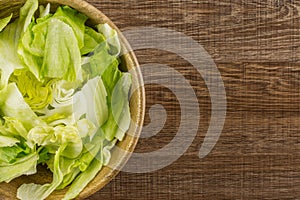 Fresh raw Iceberg Lettuce on brown wood