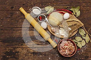 Fresh raw ingredients for the preparation of dumplings, ravioli, savory pies, quiche. Stuffing, flour, dough, eggs, spices