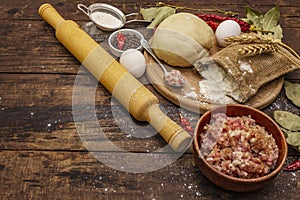 Fresh raw ingredients for the preparation of dumplings, ravioli, savory pies, quiche. Stuffing, flour, dough, eggs, spices