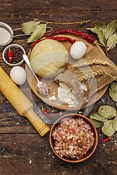 Fresh raw ingredients for the preparation of dumplings, ravioli, savory pies, quiche. Stuffing, flour, dough, eggs, spices