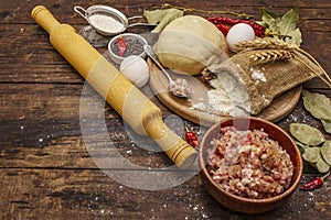 Fresh raw ingredients for the preparation of dumplings, ravioli, savory pies, quiche. Stuffing, flour, dough, eggs, spices