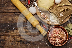 Fresh raw ingredients for the preparation of dumplings, ravioli, savory pies, quiche. Stuffing, flour, dough, eggs, spices