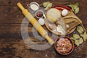 Fresh raw ingredients for the preparation of dumplings, ravioli, savory pies, quiche. Stuffing, flour, dough, eggs, spices