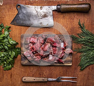 Fresh raw lamb chop on a cutting board for meat cleaver Meat fork herbs top view close up on wooden rustic background