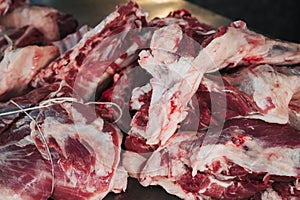 Fresh raw lamb meat on counter for cooking traditional Uzbek pilaf in butcher market in Tashkent in Uzbekistan