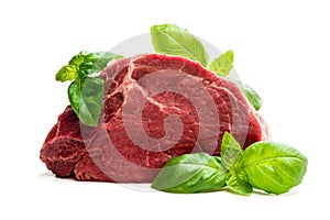 Fresh raw meat beef piece with basil leaf isolated on white background
