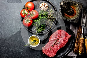 Fresh raw meat beef steak. Beef tenderloin, spices, herbs and vintage cutlery. Food background with copy space