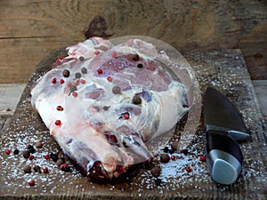 Fresh and raw meat. Leg of lamb with knife for roasting, stewing, pilaf, barbecue, kebab, shurpa