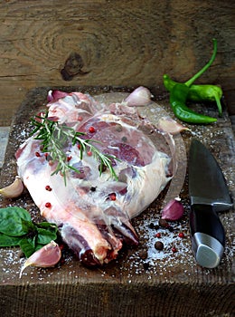 Fresh and raw meat. Leg of lamb with spices with knife for roasting, stewing, pilaf, barbecue, kebab, shurpa