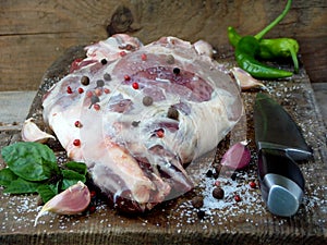 Fresh and raw meat. Leg of lamb with spices with knife for roasting, stewing, pilaf, barbecue, kebab, shurpa