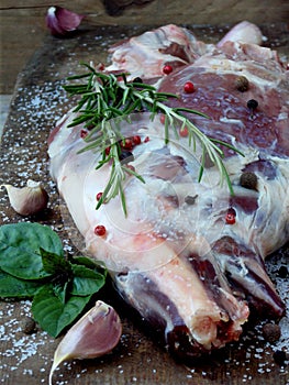 Fresh and raw meat. Leg of lamb with spices with a knife for roasting, stewing, pilaf, barbecue, kebab, shurpa