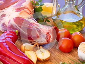 Fresh and raw meat. Leg of lamb on wood background. Spain.