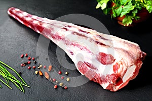 Fresh and raw meat. Raw oxtail ready to cook. Background black blackboard