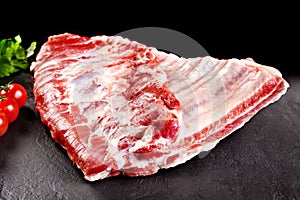 Fresh and raw meat. Ribs and pork chops uncooked, uncut ready to grill and barbecue.