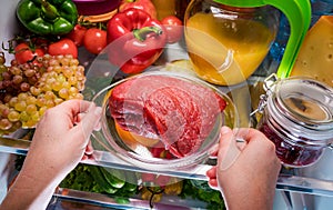 Fresh raw meat on a shelf open refrigerator