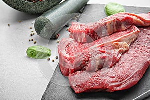 Fresh raw meat on slate plate, closeup