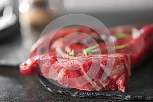 Fresh raw meat with spices on slate plate, closeup