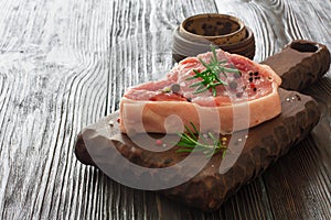 Fresh raw meat for steak on wooden cutting board