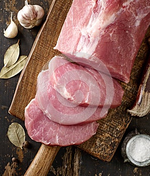 Fresh raw meat on wooden cutting board