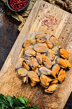 Fresh raw mussel meat on a wooden chopping Board. Healthy seafood