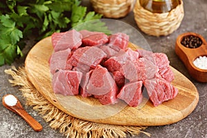 Fresh raw organic beef slices on a cutting board.