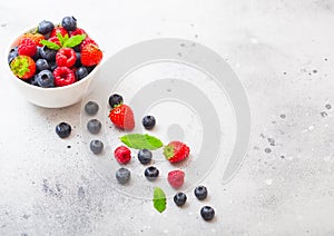 Fresh raw organic berries isolated in white ceramic bowl plate on kitchen table background. Top view. Strawberry, Raspberry,