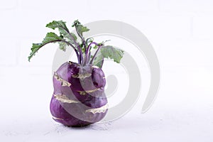Fresh raw organic purple kohlrabi on white