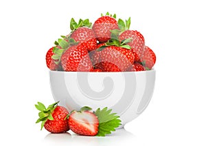 Fresh raw organic strawberries in white ceramic bowl plate on white background with berries next to it