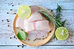 Fresh raw pangasius fish fillet with herb and spices black pepper lemon lime and rosemary, meat dolly fish tilapia striped catfish