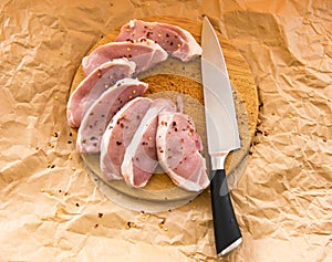 Fresh raw pork chops on a cutting board. Arrangement on the wr