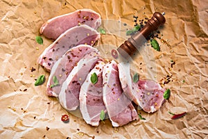 Fresh raw pork chops on a cutting board  on the wrapping paper