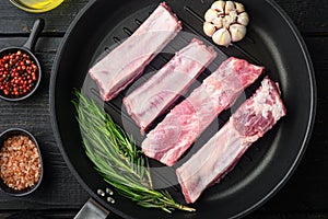Fresh raw pork meat from organic farm with spices, in cast iron frying pan, top view flat lay
