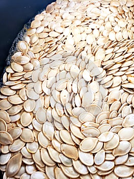 Fresh and raw pumpkin seeds soaking in salt water