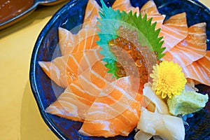 Fresh raw salmon with salmon eggs or Ikura and wasabi on topped rice bowl donburi