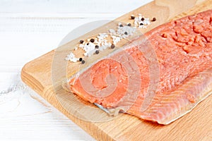 Fresh raw salmon fille. Red fish with salt and pepper