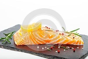 Fresh raw salmon fillet with rosemary and lemon