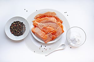 Fresh raw salmon fish fillet on a white plate