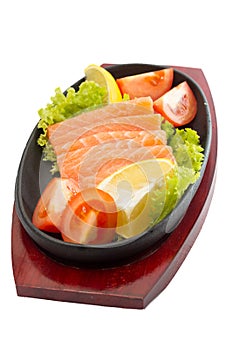 Fresh raw salmon fish pieces on plate isolated