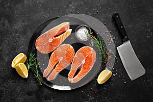 Fresh raw salmon fish steaks with cooking ingredients on kitchen table, healthy food, source of omega-3