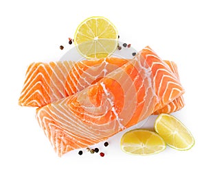 Fresh raw salmon with pepper, lime and lemon on background, top view. Fish delicacy