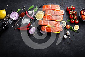 Fresh raw salmon red fish fillet on black background