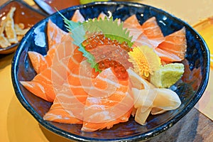 fresh raw salmon with salmon eggs or Ikura and wasabi on topped rice bowl donburi