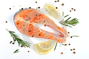 Salmon steak on a white background with lemon and spices