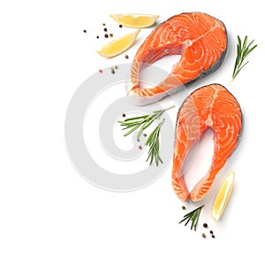 Fresh raw salmon steaks with rosemary and lemon on white background