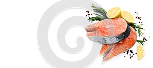 Fresh raw salmon steaks with rosemary, peppercorns and lemon on white background, top view. Banner design