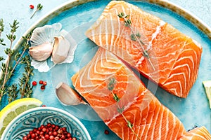 Fresh raw salmon or trout fillets with ingredients