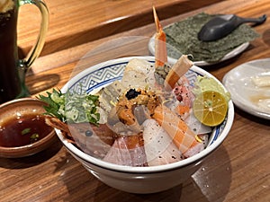 Fresh raw seafood mixed rice bowl. Kaisen-Don. Japanese rice with sashimi of shrimp, tuna, Otoro, salmon, sea urchin, Engawa